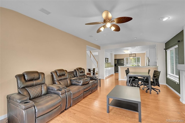 2631 S Flanders Ct, Aurora, CO 80013 - living room featuring lofted ceiling, light wood-type flooring, a ceiling fan, stairs, and baseboards
