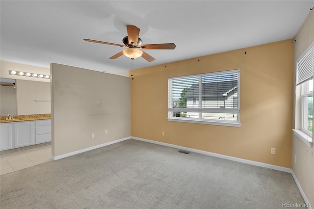 2631 S Flanders Ct, Aurora, CO 80013 - empty room featuring a ceiling fan, light carpet, a sink, and baseboards