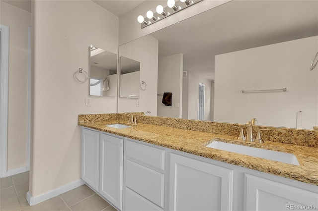 2631 S Flanders Ct, Aurora, CO 80013 - bathroom with tile patterned floors, double vanity, and baseboards