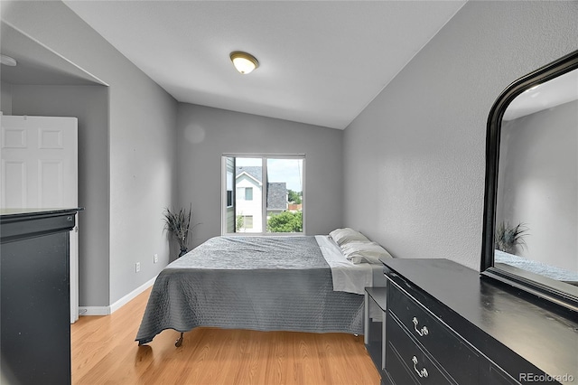 2631 S Flanders Ct, Aurora, CO 80013 - bedroom featuring light wood finished floors, vaulted ceiling, and baseboards