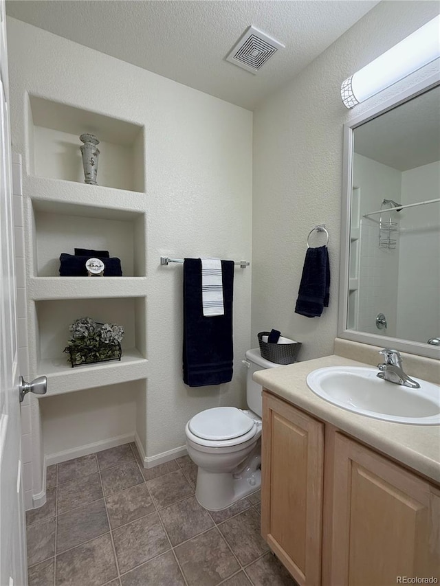 452 Black Feather Loop Unit 612, Castle Rock, CO 80104 - full bath with toilet, vanity, a shower, baseboards, and a textured ceiling