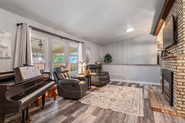 sitting room featuring a fireplace, wood finished floors, and baseboards