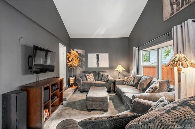 carpeted living room featuring vaulted ceiling