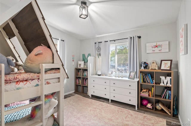 bedroom featuring baseboards and wood finished floors