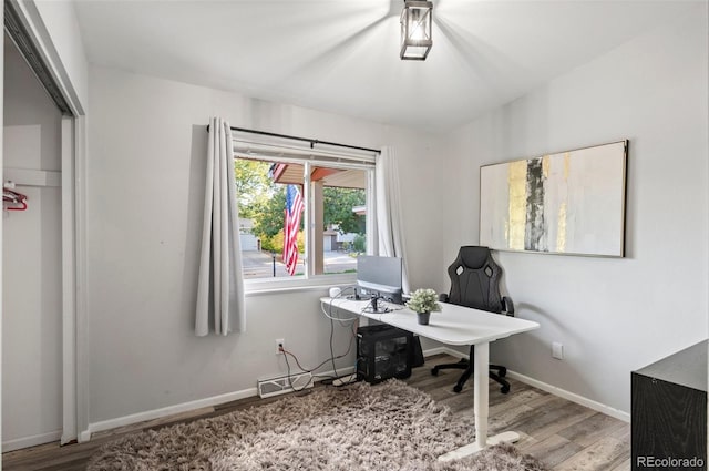 office space featuring wood finished floors and baseboards