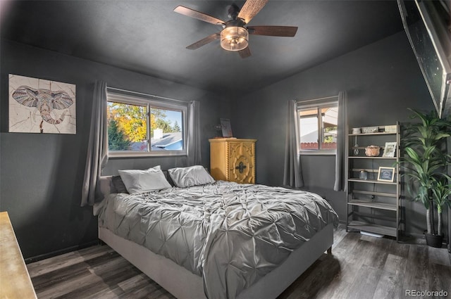 bedroom featuring a ceiling fan, vaulted ceiling, and wood finished floors