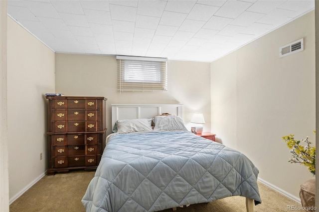 bedroom with carpet floors, visible vents, and baseboards