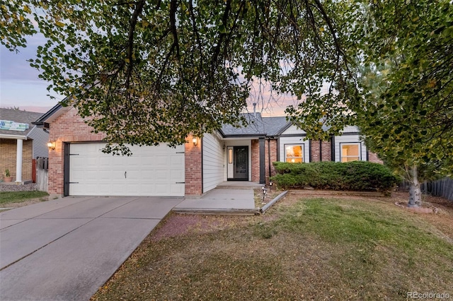 view of front of property featuring a garage and a yard