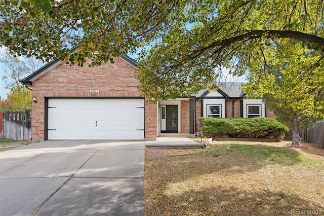 view of front of home with a garage and a front lawn