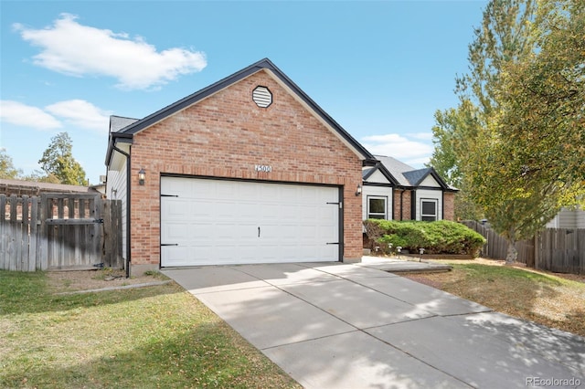 view of front of house featuring a garage and a front lawn