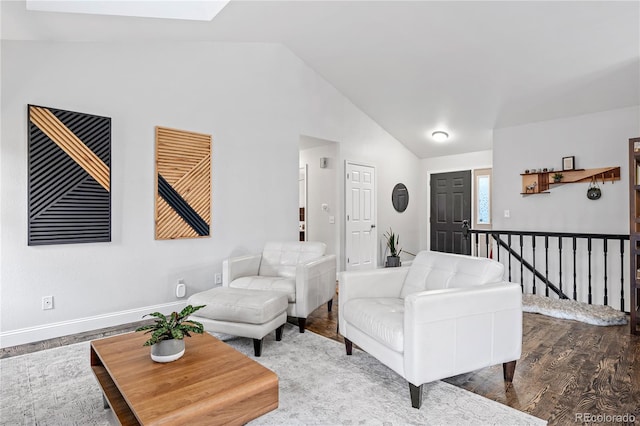 living room with hardwood / wood-style flooring and lofted ceiling with skylight