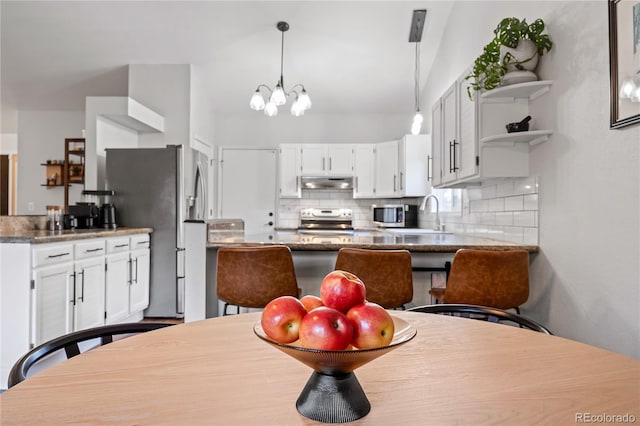 dining room with sink and a chandelier