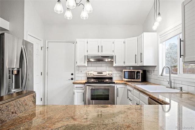 kitchen featuring white cabinetry, sink, decorative light fixtures, backsplash, and stainless steel appliances