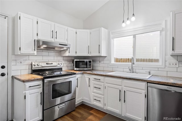 kitchen featuring sink, white cabinets, decorative light fixtures, and appliances with stainless steel finishes