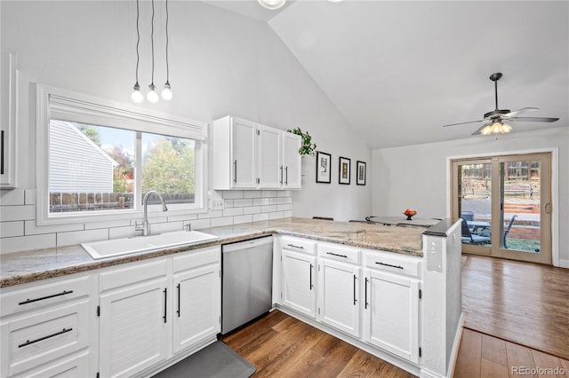 kitchen featuring dishwasher, white cabinetry, sink, backsplash, and kitchen peninsula