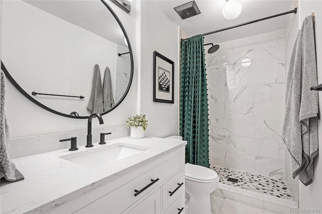 bathroom with vanity, toilet, and curtained shower