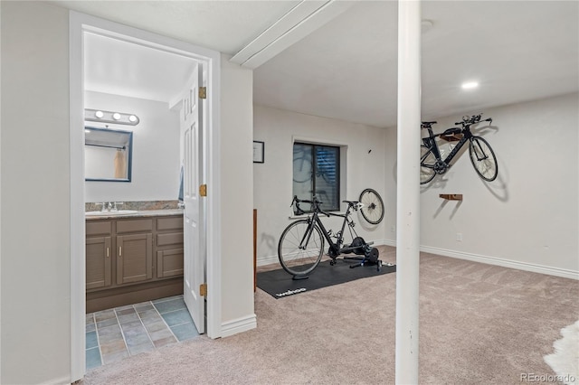 workout room with sink and light carpet