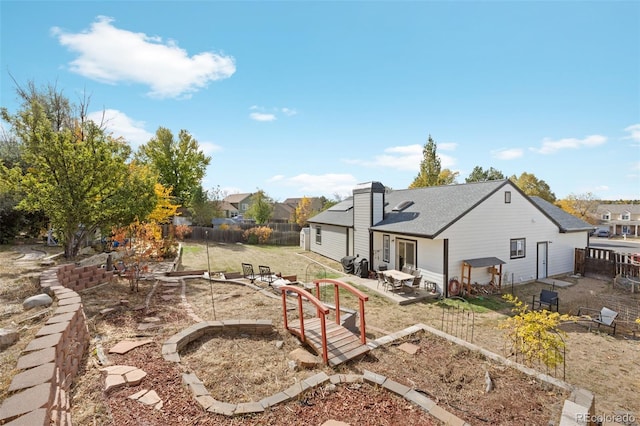 back of property featuring a lawn and a patio