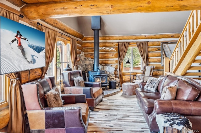 795 Zebulon St, Alma, CO 80420 - living area with rustic walls, a wood stove, hardwood / wood-style flooring, beamed ceiling, and stairs