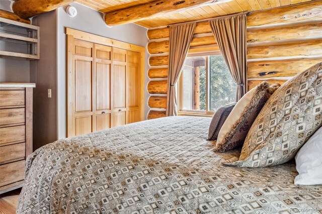 795 Zebulon St, Alma, CO 80420 - bedroom featuring rustic walls, wooden ceiling, beam ceiling, and a closet