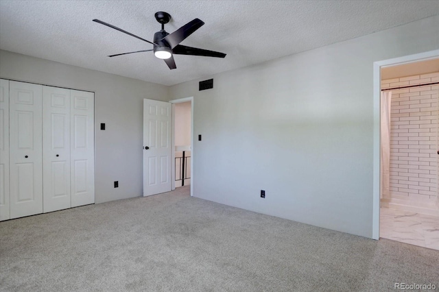 6844 S Broadway, Littleton, CO 80122 - unfurnished bedroom with carpet floors, a textured ceiling, ensuite bath, a closet, and ceiling fan