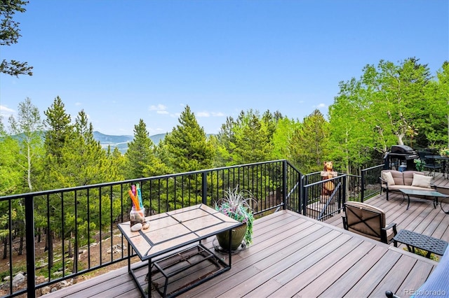 11094 Thomas Dr, Conifer, CO 80433 - wooden terrace featuring outdoor dining area and a view of trees