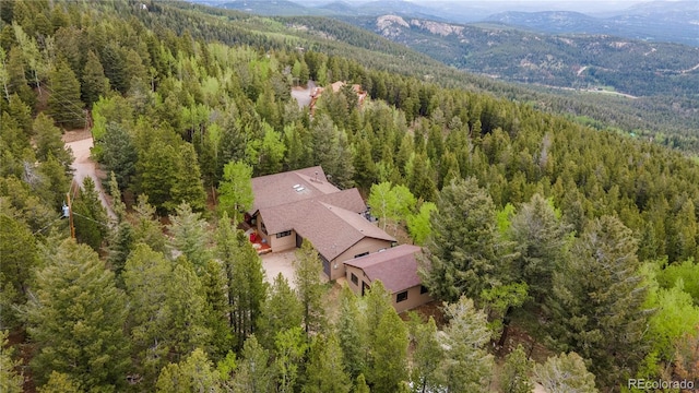 11094 Thomas Dr, Conifer, CO 80433 - aerial view of property and surrounding area featuring a forest and a mountainous background