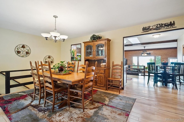 11094 Thomas Dr, Conifer, CO 80433 - dining area featuring a chandelier and light wood finished floors