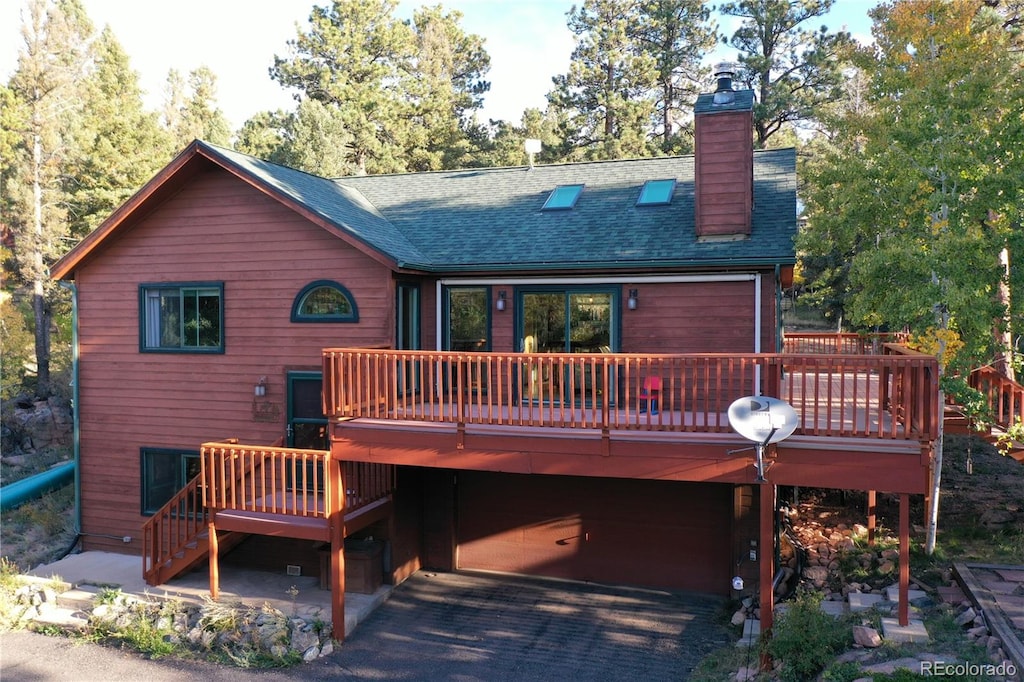 rear view of property with a wooden deck