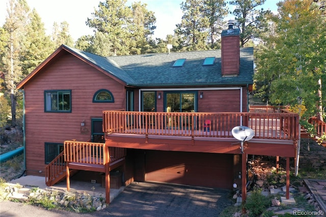 rear view of property with a wooden deck