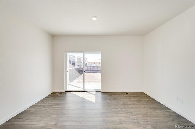 empty room with wood-type flooring