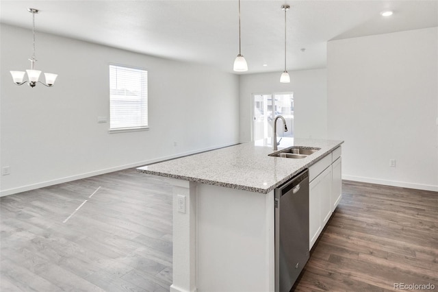 kitchen featuring sink, white cabinetry, light stone counters, decorative light fixtures, and dishwasher