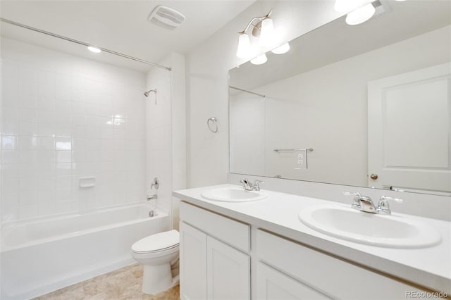 full bathroom with vanity, toilet, and tiled shower / bath