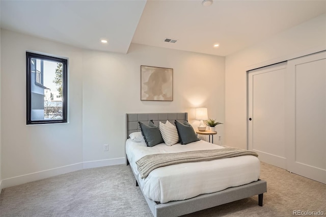 bedroom featuring a closet and light carpet