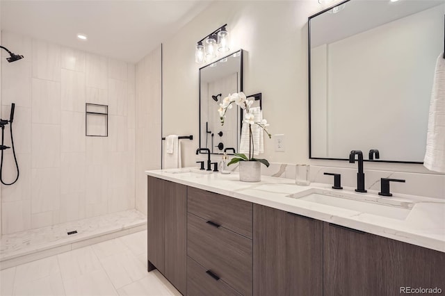 bathroom with vanity, tile patterned flooring, and tiled shower