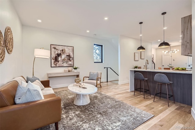 living room with sink and light wood-type flooring