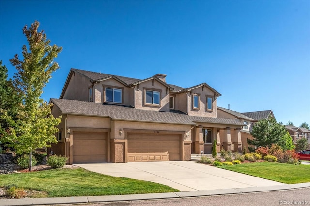 view of front of property featuring a garage and a front lawn