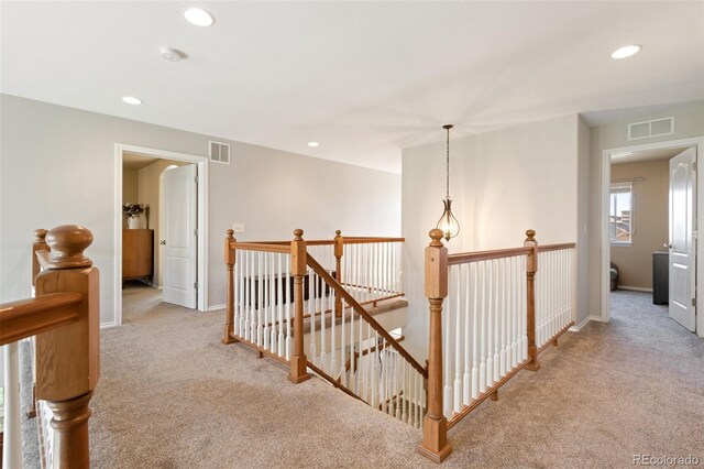 hallway featuring light carpet