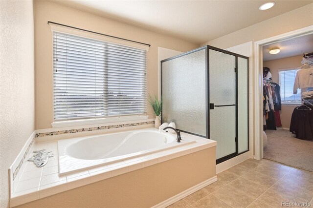 bathroom featuring tile patterned flooring and separate shower and tub