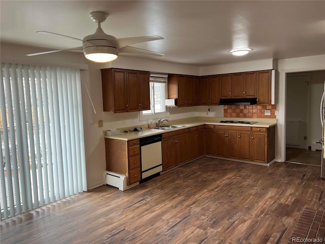 kitchen featuring sink, backsplash, stainless steel dishwasher, gas cooktop, and dark wood-type flooring