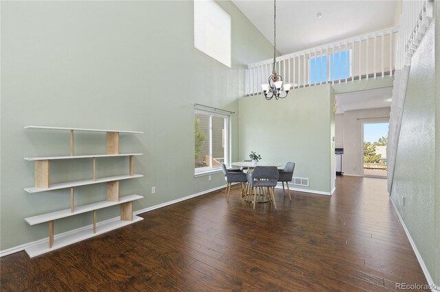 9719 Burberry Way, Highlands Ranch, CO 80129 - dining area featuring a chandelier, hardwood / wood-style floors, a high ceiling, and baseboards