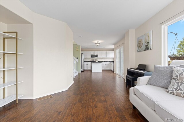 9719 Burberry Way, Highlands Ranch, CO 80129 - living room with dark wood-type flooring and baseboards