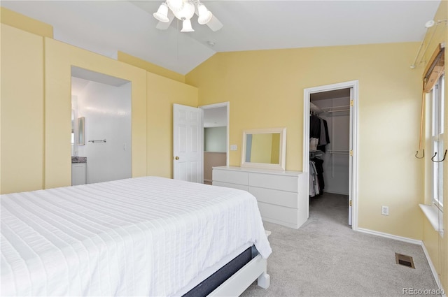 9719 Burberry Way, Highlands Ranch, CO 80129 - bedroom featuring vaulted ceiling, light colored carpet, a walk in closet, a closet, and a ceiling fan