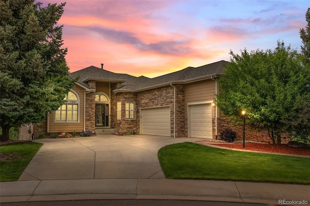 1251 Double Eagle Ct, Castle Rock, CO 80104 - view of front of home with concrete driveway, a garage, a shingled roof, a lawn, and stone siding
