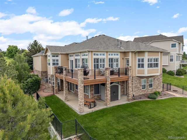 1251 Double Eagle Ct, Castle Rock, CO 80104 - rear view of property with stone siding, a patio area, a deck, a fenced backyard, and a shed