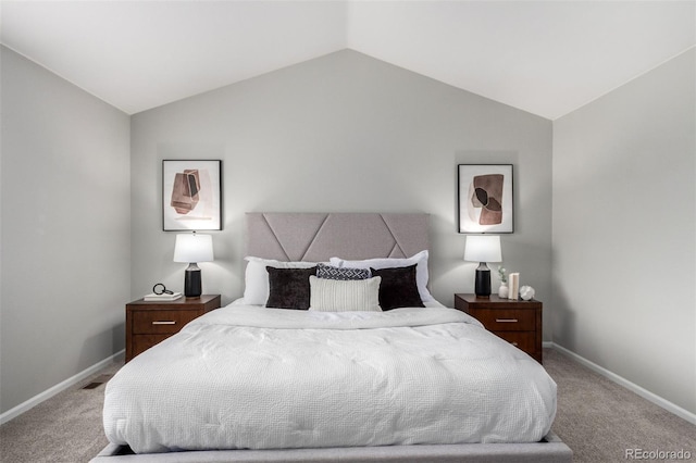 carpeted bedroom with vaulted ceiling