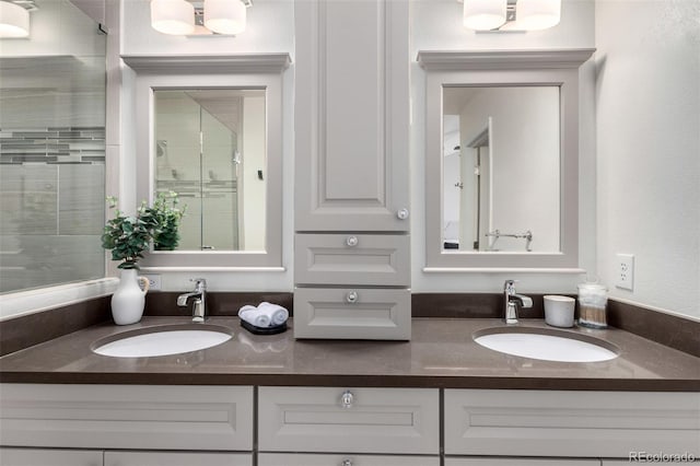 bathroom with vanity and a shower with door