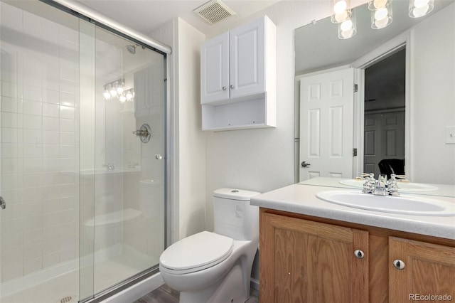 bathroom featuring walk in shower, vanity, and toilet