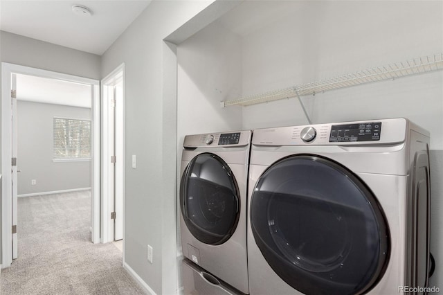 washroom with separate washer and dryer and light carpet