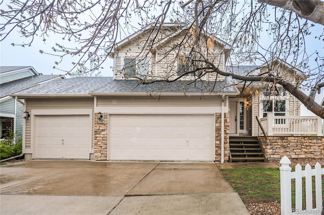 329 Lodgewood Ln, Lafayette, CO 80026 - view of front of home featuring concrete driveway, a garage, a shingled roof, and fence